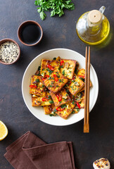 Fried tofu with peppers, garlic and herbs. Vegetarian food. Healthy eating. Diet.
