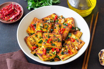 Fried tofu with peppers, garlic and herbs. Vegetarian food. Healthy eating. Diet.