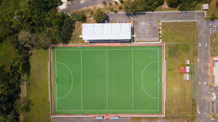 Aerial view of an artificial grass field hockey pitch. The sports center is empty and there is no...