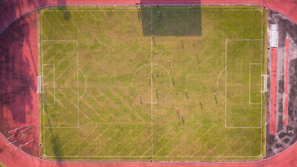 Aerial Top Down View of Soccer Football Field and Two Amateur Teams Playing. Passing, Dribbling,...