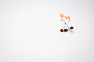 Cigarette, cigarette on a wooden background, three of cigarettes, a close-up of a cigarette.
