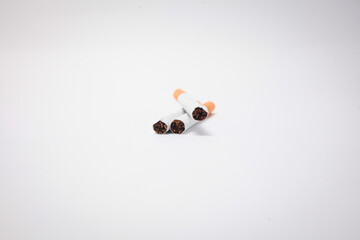 Cigarette, cigarette on a wooden background, three of cigarettes, a close-up of a cigarette.