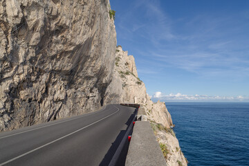 Coastal road winding along a cliff - 775781353