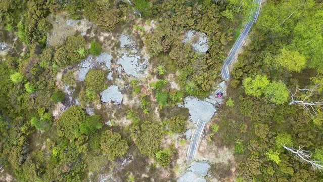 Forest path leading up to Stolanuten hill top in Nedstrand, Norway, 4K drone.