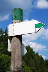 Wooden signpost with one arrow - tourist trail