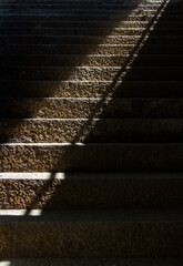 Stone stairs with light beam and shadow from a underway