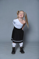 Girl with a radiant smile twirls, hair in playful pigtails. Reflects the uninhibited joy and dynamic movement of youth.