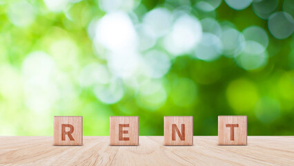 Wooden blocks with word Rent, concept of renting housing and real estate. cost of rented home or apartment, Saving money, Rental. business concept.
