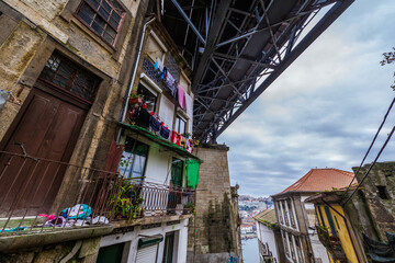 Tenement houses under the Dom Luis I Bridge in Porto city, Portugal