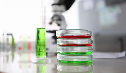 Close-up of laboratory glass containers and flask with colored liquid. Researching biotechnology and pharmacy industry for human. Chemical experiments concept