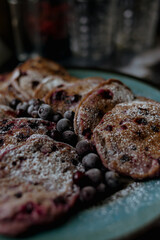 pancakes with raspberries in white plate
