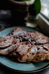 pancakes with raspberries in white plate