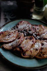 pancakes with raspberries in white plate