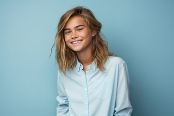 Obraz premium A girl with long hair is smiling and wearing a blue shirt