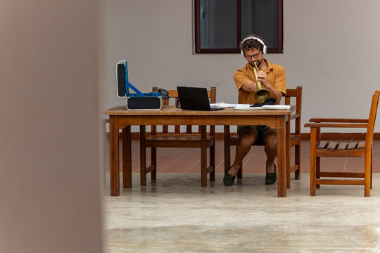 One-Armed Trumpeter Practicing in Courtyard
