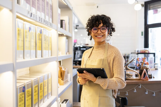 Small business owner using tablet in boutique shop