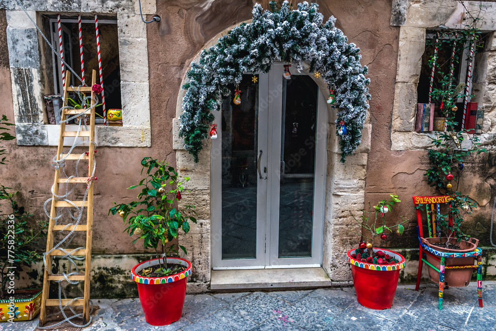 Sticker Christmas decorations on a street on Ortygia island, old part of Syracuse city, Sicily, Italy