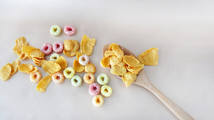 Top view of Corn Flakes and Fruit Loops Cereal on Background