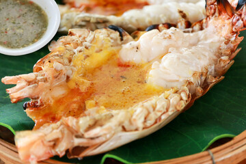 Close-up of grilled giant River Prawn or River Shrimp on the wooden plate with sea foods sauce of...
