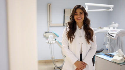 Portrait of a beautiful, young female dentist at her office