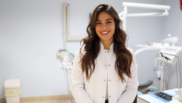 Portrait of a beautiful, young female dentist at her office