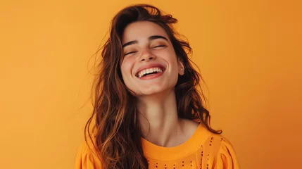 Foto op Plexiglas Smiling woman with positive charisma in front of a simple orange background © Laura