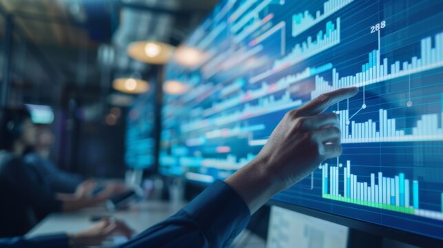 Person Pointing at Graphs on Screen