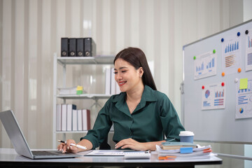 Beautiful business woman with determination Working on laptop in modern office
