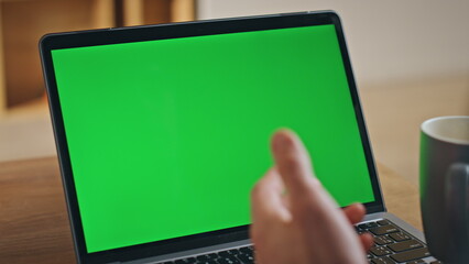 Unrecognized man talking video conference using green screen laptop close up.