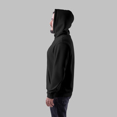 Mockup of a black oversized hoodie on a bearded man in a hood, side view, clothing with pocket, isolated on background.