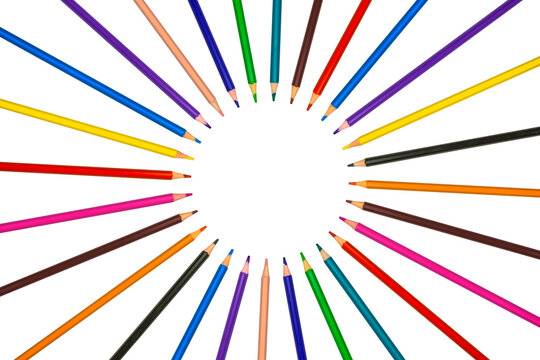 Horizontal image with colored pencils forming a colorful circle on white background
