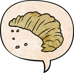 cartoon croissant with speech bubble in retro texture style