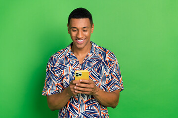 Photo of cheerful attractive blogger wearing summer print clothes writing texting post comment...
