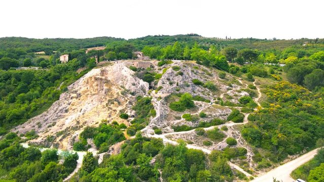 Bagno Vignoni natural pools along the city hill in Tuscany, view in spring season from drone