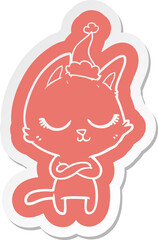 calm quirky cartoon  sticker of a cat wearing santa hat