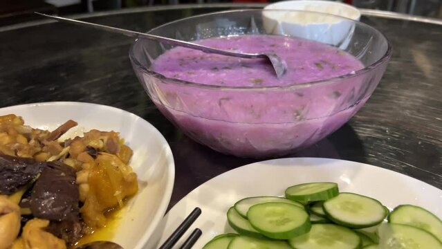 Red cabbage cream decorated with liquid cream. Vietnamese purple cream vegetable soup