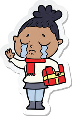sticker of a cartoon crying woman with christmas gift