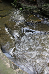 Water flowing over natural rock.