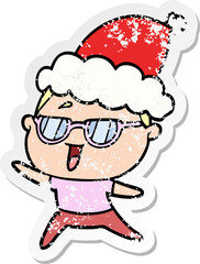 hand drawn distressed sticker cartoon of a happy woman wearing spectacles wearing santa hat