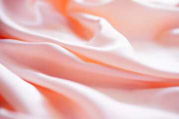 Light pink silk or satin wavy background beautiful and luxurious Space for design. Close-up. Blurred or blurry. - obrazy, fototapety, plakaty