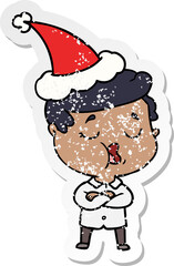 hand drawn distressed sticker cartoon of a man talking wearing santa hat