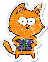 distressed sticker of a cartoon cat holding christmas present