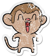distressed sticker of a cartoon laughing monkey