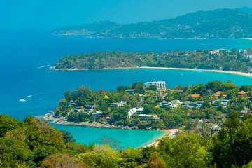 Deurstickers Viewpoint of Karon Beach, Kata Beach and Kata Noi in Phuket, Thailand. The beautiful coastal basin and surrounding buildings are visible from a distance and the sky is blue from a high vantage point. © Yasuspade