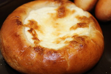 bread on a plate, cheesecake, bun with cottage cheese