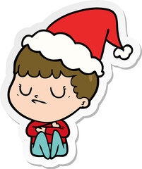 hand drawn sticker cartoon of a grumpy boy wearing santa hat