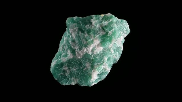 Amazonite (potassium feldspar / microcline) sample rotating slowly against a black background.
