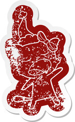 quirky cartoon distressed sticker of a singing cat wearing santa hat