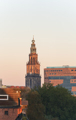 The Martinitoren and teh Forum building on a clear morning in the historical city centre of Groningen.