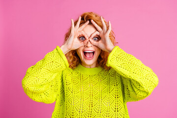 Photo of funny lovely crazy girl wear trendy green clothes look binoculars isolated on vibrant pink...